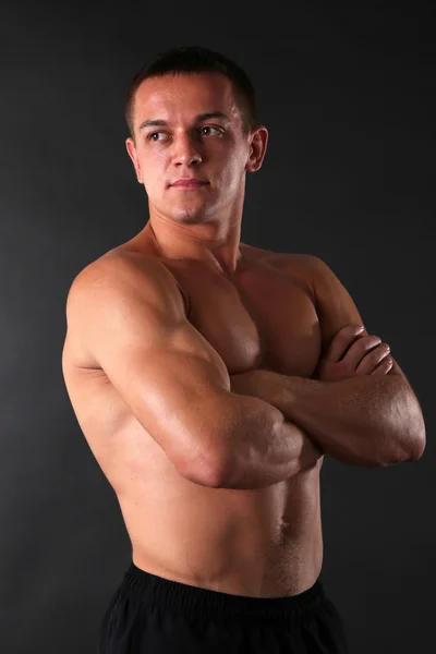 Hombre joven musculoso guapo sobre fondo oscuro —  Fotos de Stock