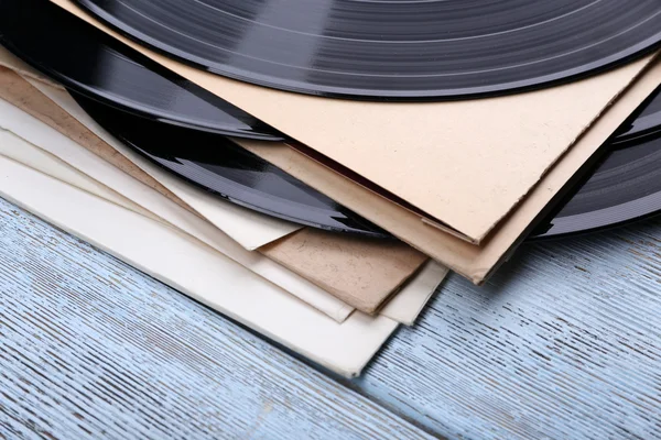 Registros de vinilo y cubiertas de papel sobre fondo de madera —  Fotos de Stock