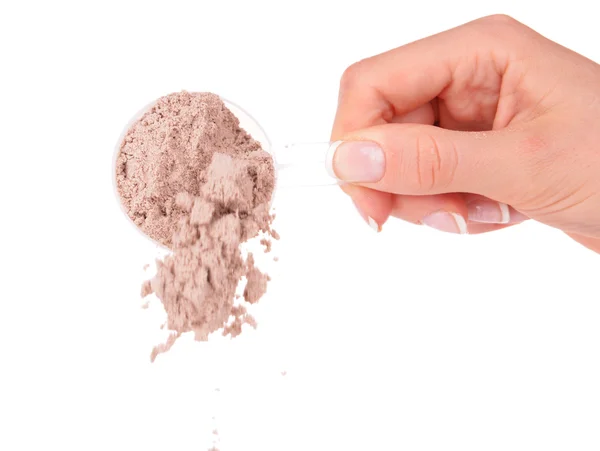 Female hand holding scoop with whey protein powder isolated on white