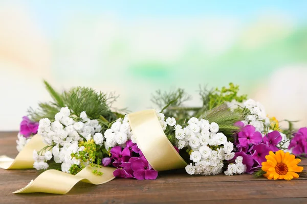 Flower wreath on wooden background — Stock Photo, Image