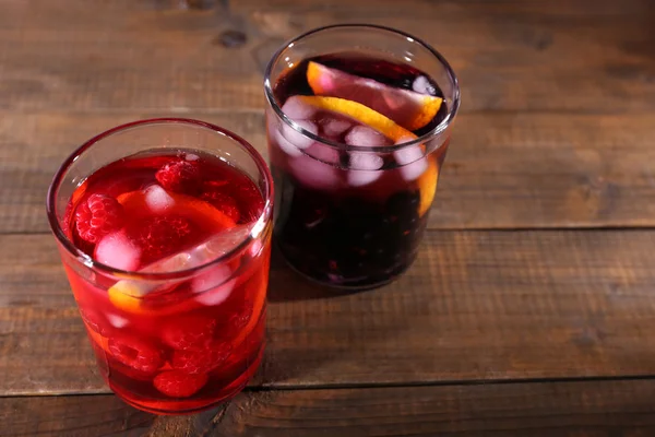 Glasses of cold berry cocktail on wooden background — Stock Photo, Image