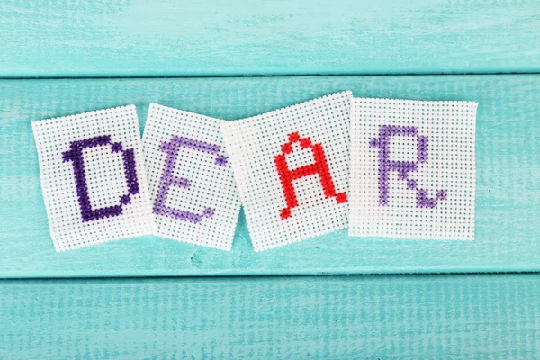 Palavra feita de cartas bordadas — Fotografia de Stock