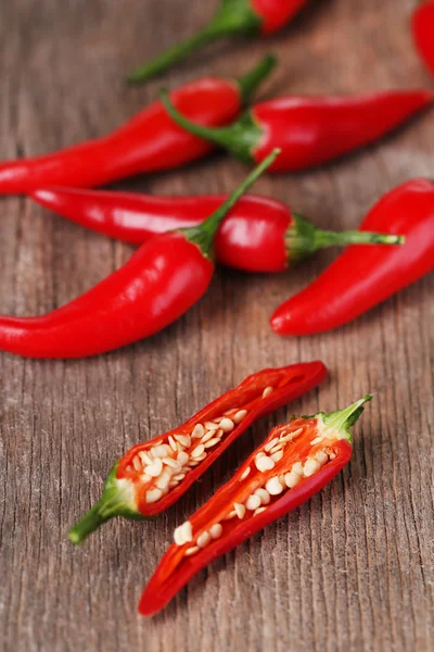 Red hot chili peppers on wooden background — Stock Photo, Image