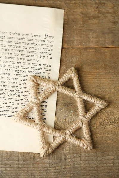 Star of David and page of Genesis book on wooden background — Stock Photo, Image