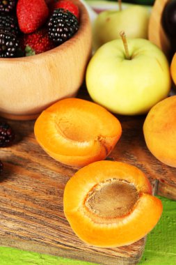 Olgunlaşmış meyve ve çilek kase masa üzerinde kapat