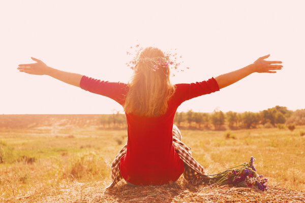 Woman waiting for summer sun on meadow