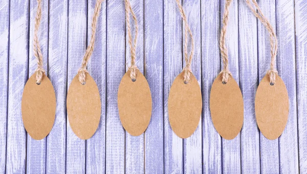 Brown tags on wooden background — Stock Photo, Image