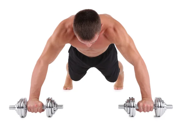 Bonito jovem desportista muscular executar exercício com halteres isolados em branco — Fotografia de Stock