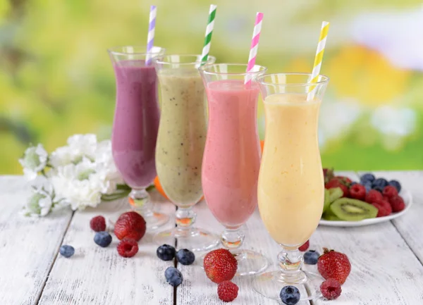 Delicious berry cocktails on table on bright background — Stock Image Delicious berry cocktails on table on bright background Stock Image
