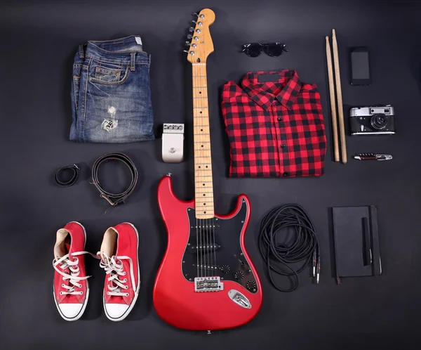 Music equipment, clothes and footwear on black background — Stock Photo, Image
