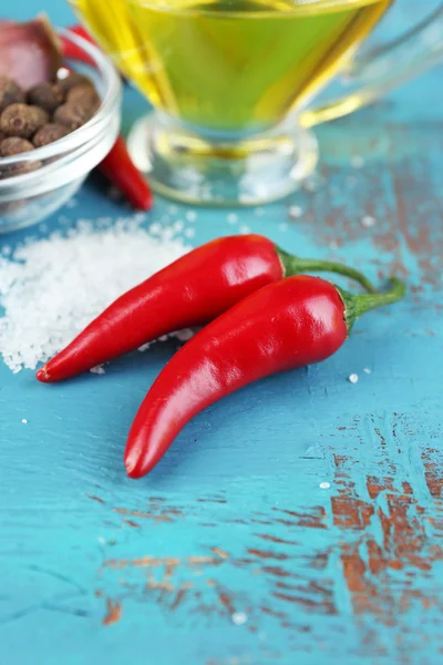 Set of spices and olive oil in glass sauce-boat, on color  wooden background — Stock Photo, Image