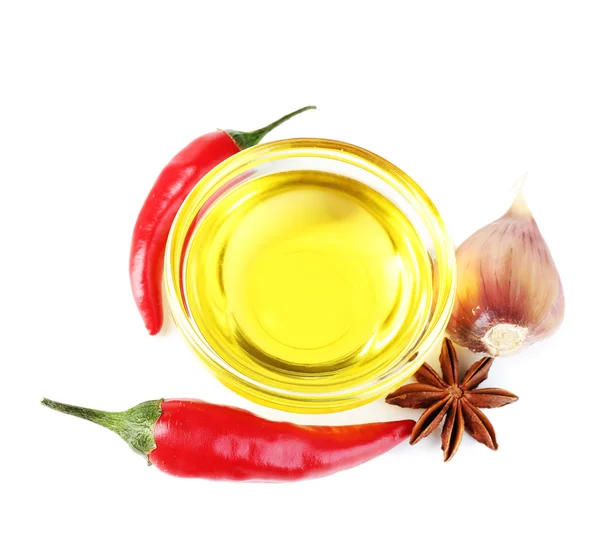 Homemade natural infused olive oil in glass bowl with red chili peppers, garlic isolated on white — Stock Photo, Image