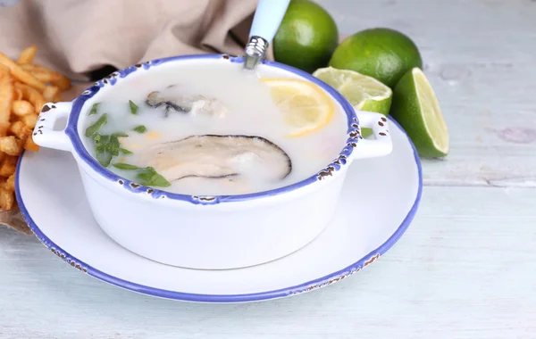Tasty soup with oysters on wooden table — Stock Photo, Image