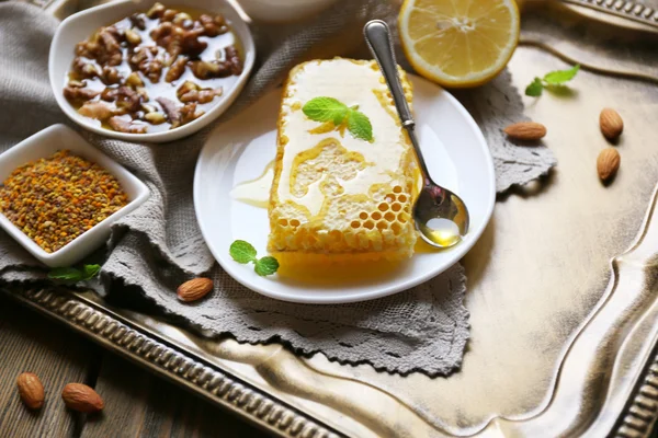 Fresh honey snack on tray on wooden table — Stock Photo, Image