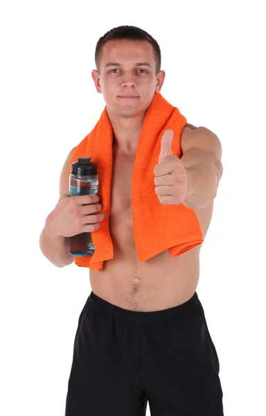 Handsome young sportsman holding towel and bottle with water isolated on white — Stock Photo, Image