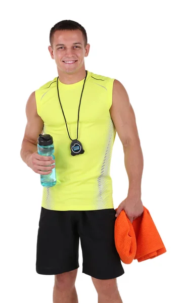 Przystojny młody sportowiec trzymając ręcznik i butelkę z wodą na białym tle — Zdjęcie stockowe