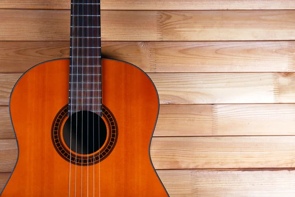 Acoustic guitar on wooden background — Stock Photo, Image