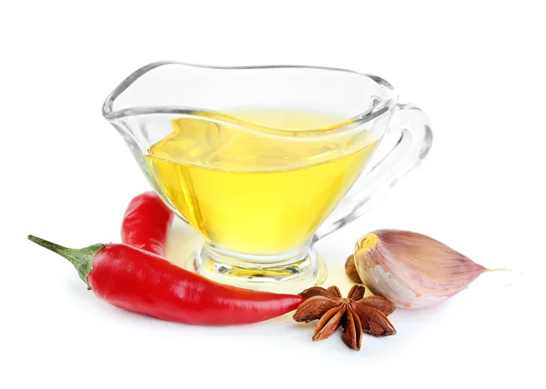 Homemade natural infused olive oil in glass sauce-boat with red chili peppers, garlic isolated on white — Stock Photo, Image