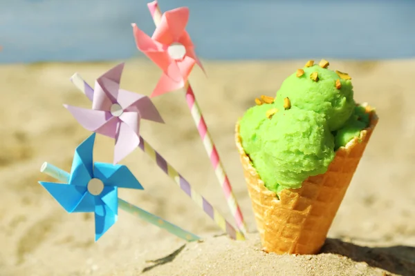 Ice cream in sand on beach — Stock Photo, Image