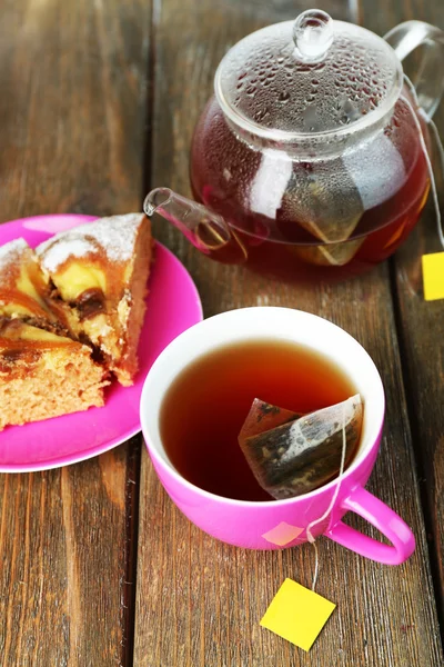 Çaydanlık ve ahşap masa yakın çekim üzerinde çay poşetleri çay bardağı — Stok fotoğraf