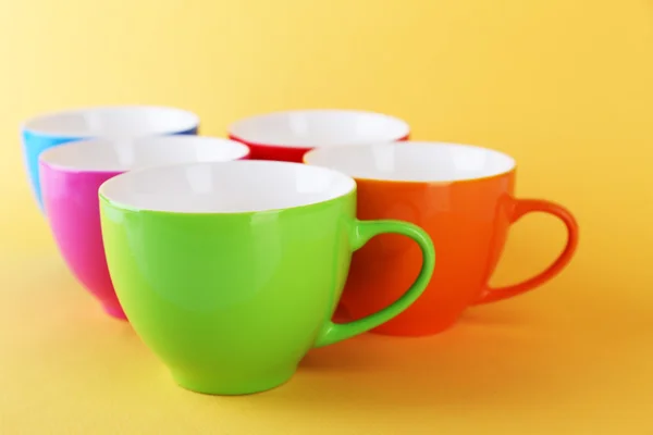 Colorful cups on color background Stock Picture