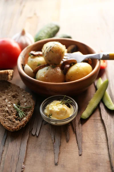 Unga kokt potatis i skål på träbord — Stockfoto