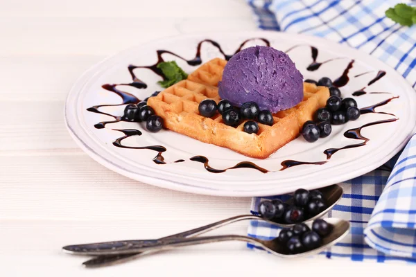 Tasty belgian waffles with ice cream on wooden table — Stock Photo, Image