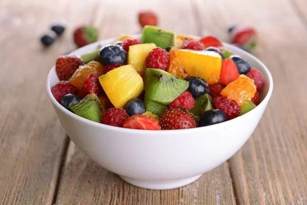 Köstlicher Obstsalat im Teller auf dem Tisch in Großaufnahme — Stockfoto