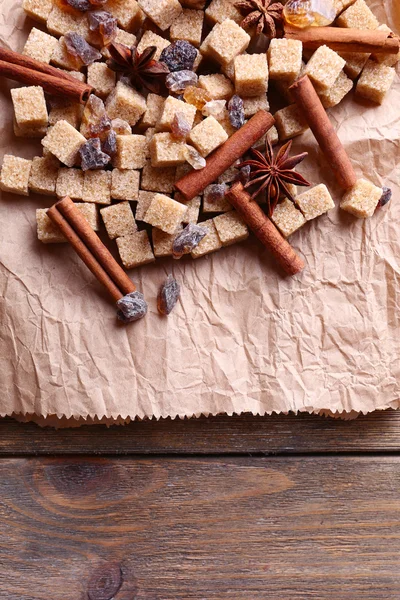 Kağıt arka plan üzerine baharat ve kahverengi şeker cubes — Stok fotoğraf