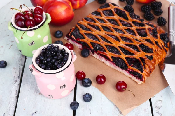 Сладкие ягоды и ягодный пирог на столе крупным планом — стоковое фото