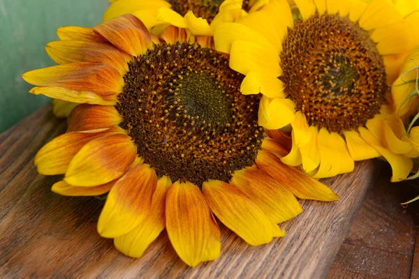 Beautiful sunflowers on wooden background — Stock Photo, Image