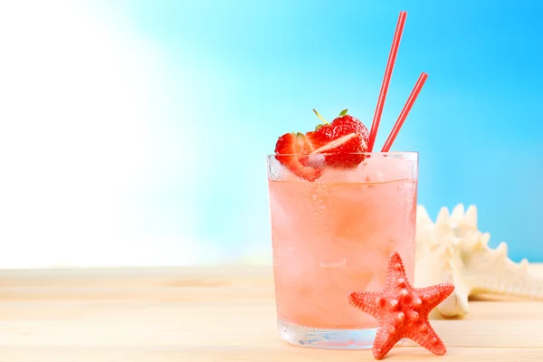 Refreshing cocktail on wooden table on blue background — Stock Photo, Image