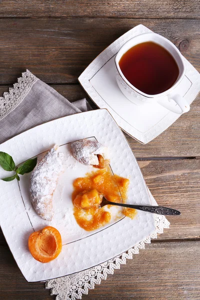 Still life with cup of tea and apricot jam on wooden table — Stock Photo, Image