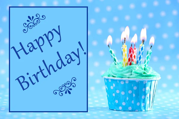 Delicious birthday cupcake on blue background — Stock Photo, Image
