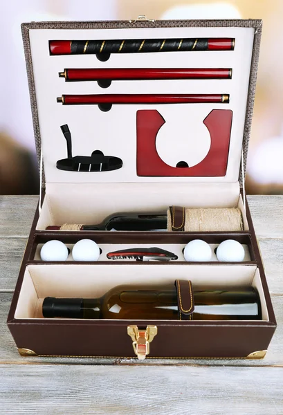 Golf set in suitcase on table on bright background — Stock Photo, Image