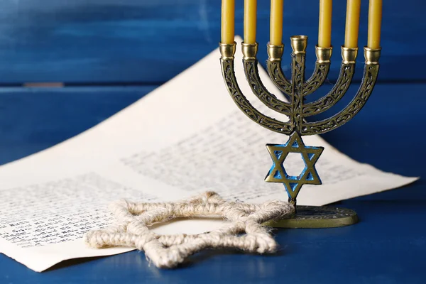 Menorah, star of David and page of Genesis book on wooden background — Stock Photo, Image