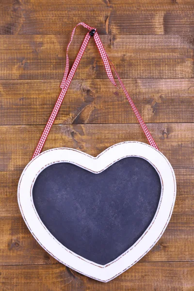 Heart shaped chalkboard on wooden background — Stock Photo, Image