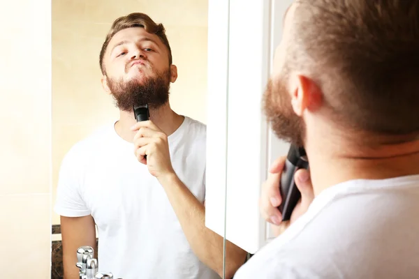 Young man shaving his beard — Stock Photo, Image