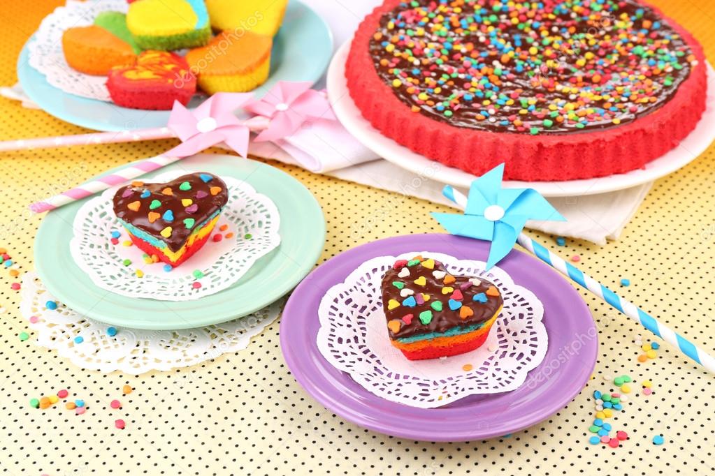 Delicious rainbow cakes on plates