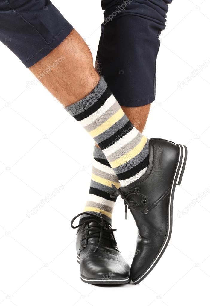 Man leg in suit and colorful socks, isolated on white 