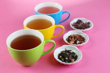 Assortment of tea on color background clipart