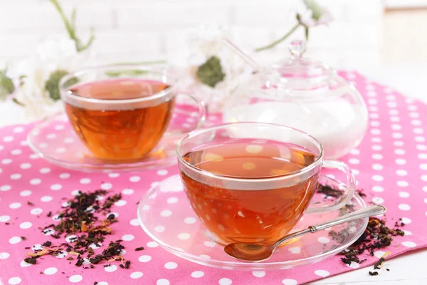 Cups of tea on table on brick wall background — Stock Photo, Image