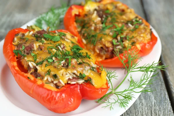 Stuffed red peppers with greens on plate — Stock Photo, Image