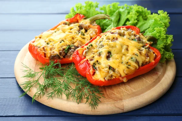 Stuffed red peppers with greens on wooden — Stock Photo, Image