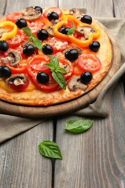 Delicious pizza served on wooden table — Stock Photo, Image