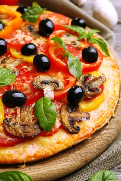 Delicious pizza served on wooden table — Stock Photo, Image