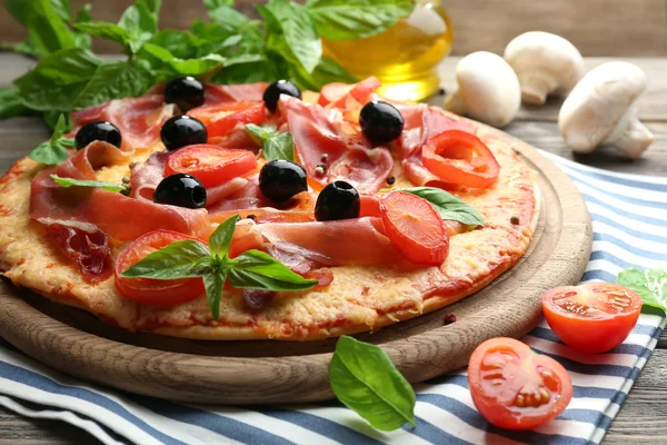 Delicious pizza served on wooden table — Stock Photo, Image