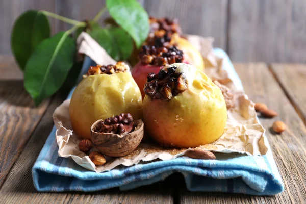 Baked apples on table on wooden background — Stock Photo, Image