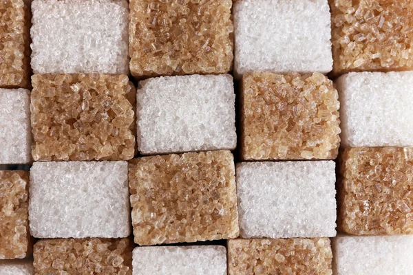 Hnědý a bílý rafinovaný cukr pozadí — Stock fotografie