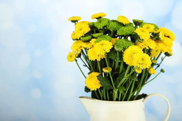 Yellow and green flowers in vase  on light background — Stock Photo, Image